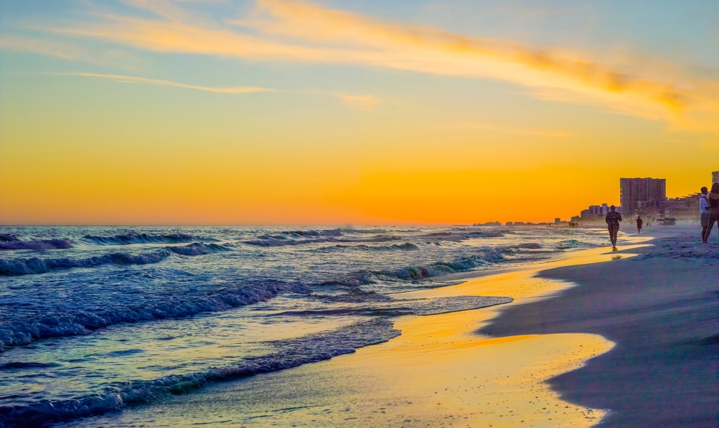 A beach with a golden sunset at Sandestin Golf and Beach resort