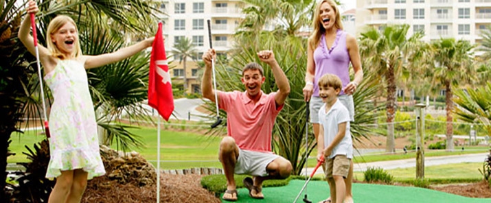 Family playing mini putt