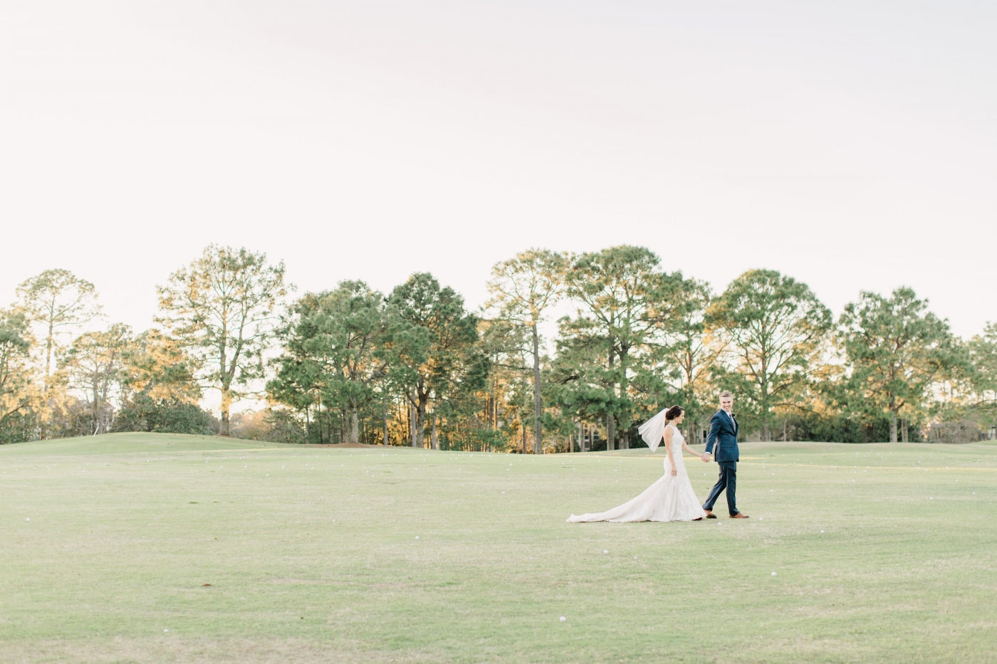 Couple walking across the golf greens at Raven