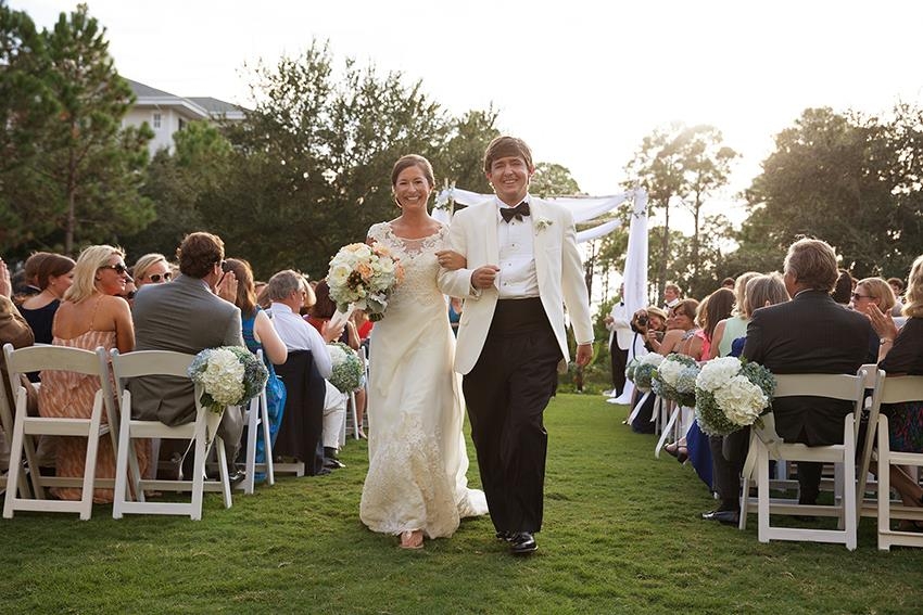 Bride and groom walking down the aisle at a garden wedding