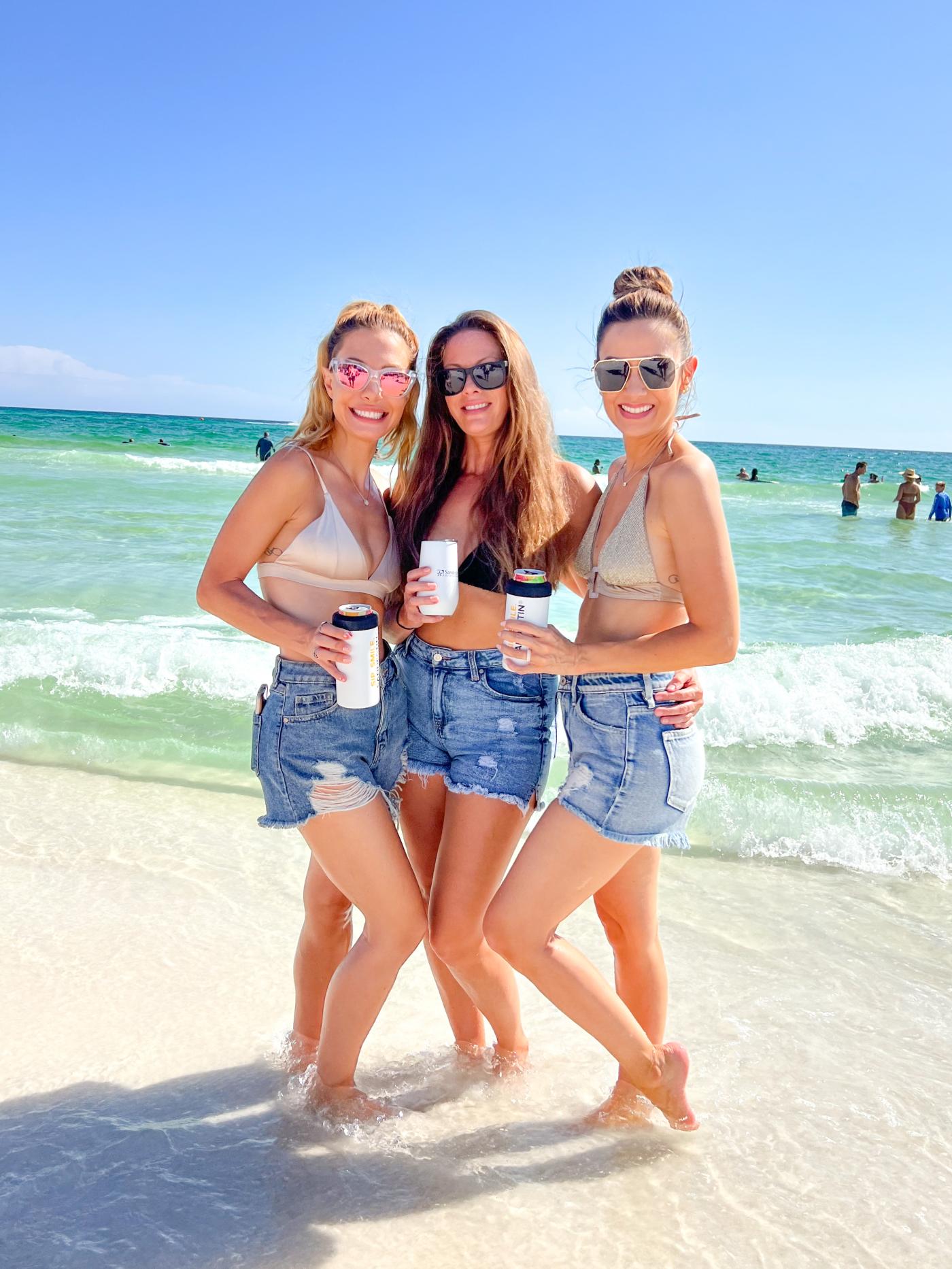 Girls standing on the beach. 