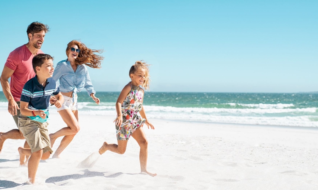 Family running on beach